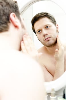 Man looks at his beard and thought about shaving