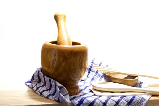 Wooden mortar and pestle on white background. Traditional kitchen equipment.