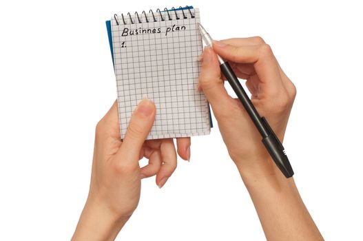 business woman writes notes for business plan