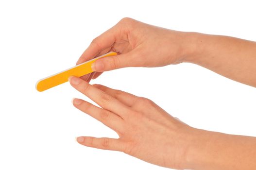 woman files her nails by emery board from manicure set