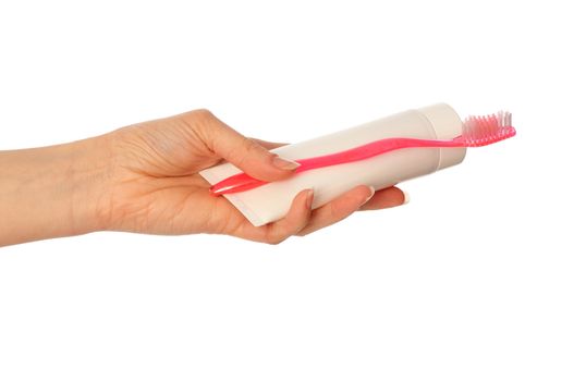 Tooth-paste and brush at in the girl's hand