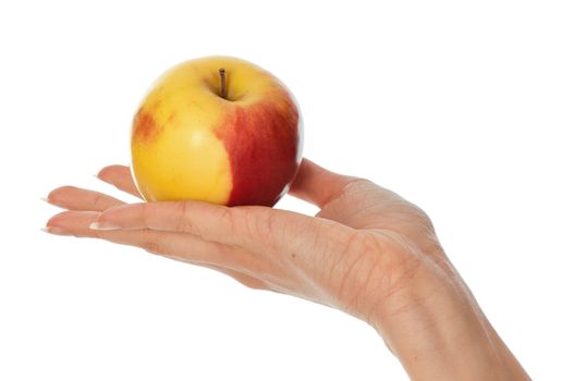 woman holding in the hand one fresh yellow with red-edged apple