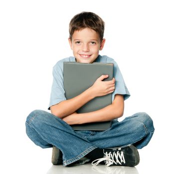 Boy holding a book on a white background