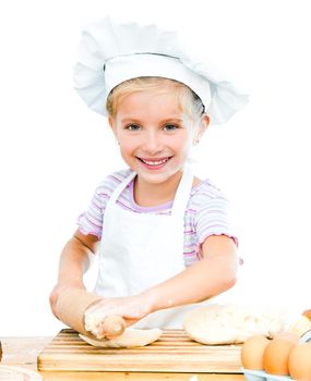 Little girl makes dough on kitchen with rolling pin