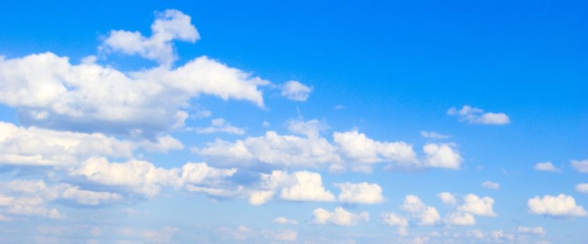 Blue sky background with tiny clouds