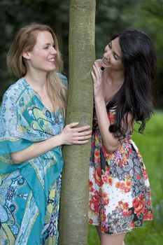 Two friends messing around in a field in summer time