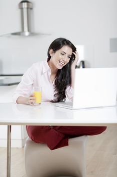 Girl using laptop at home to chat with friends