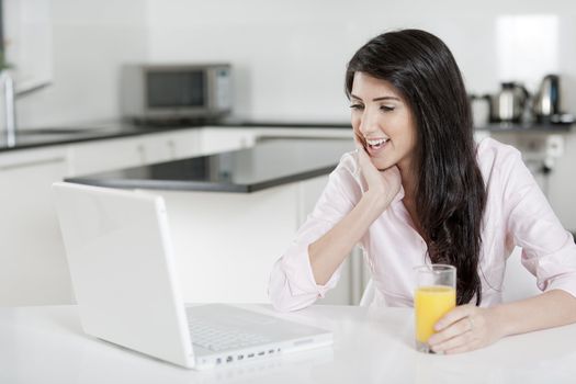 Girl using laptop at home to chat with friends