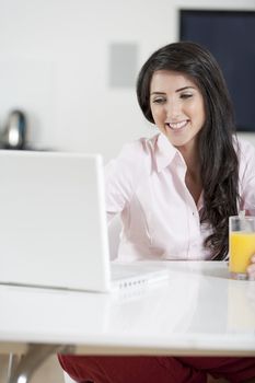 Girl using laptop at home to chat with friends