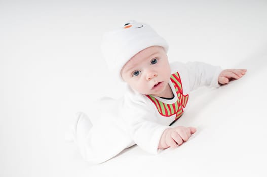 Baby in snowman costume on light background