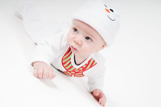 Cute baby boy in snowman costume on light background