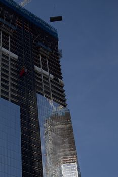 Freedom tower under construction against a blue sky
