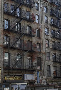Fire escapes run diagonally down colorful apartment buildings 