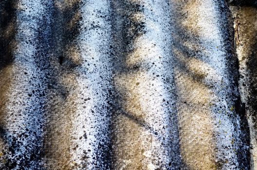 Background of old slate roofing plate texture and shadows on it.