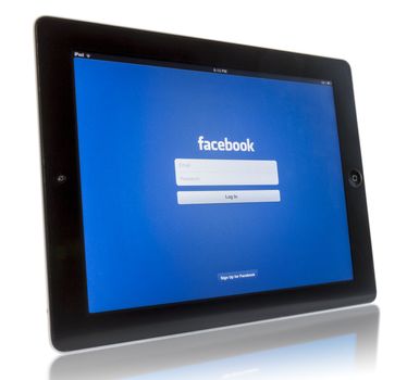 Galati, Romania - August 18, 2012: The New iPad displaying login screen of Facebook application. Studio shot on white background. 