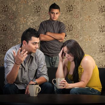 Worried Native American couple with upset son indoors