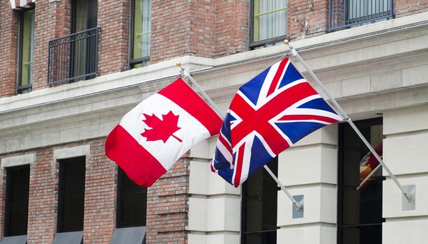 The Canadian and British flags are waving proudly side by side.