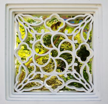 Asian design wall portal looking into green tree garden