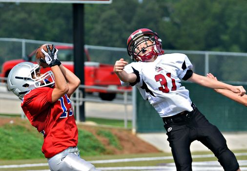 CUMMING, GA/USA - SEPTEMBER 8: Unidentified boy catching the pass at the goal line. Two teams of 7th grade boys September 8, 2012 in Cumming GA. The Wildcats  vs The Mustangs.