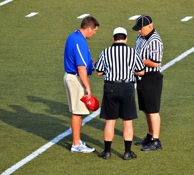 CUMMING, GA/USA - SEPTEMBER 8: Unidentified coach and officials before a football game of 7th grade boys September 8, 2012 in Cumming GA. The Wildcats  vs The Mustangs.