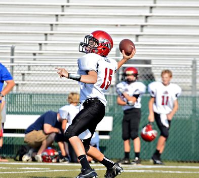 CUMMING, GA/USA - SEPTEMBER 8: Unidentified boy ready to throw a pass during a football game. A team of 7th grade boys September 8, 2012 in Cumming GA. The Wildcats  vs The Mustangs.