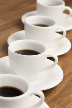 Row of white coffee cups on the table.