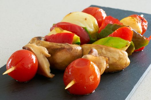 Vegetable brochettes on a black slate tray