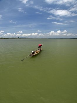 Fisherman use his net to catching some fish from Mekong river in southern Laos