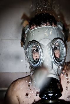 Man in gas mask with water reflection in the eyes over artistic background