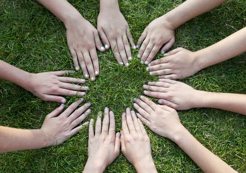 all hands together on the grass  as a team 