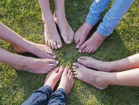 all feet together on the grass