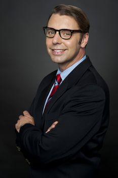 Portrait of confident business representative posing with arms folded. Studio shot