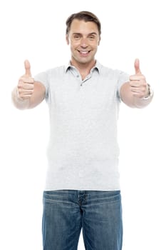 Good looking cheerful man showing double thumbs up to camera