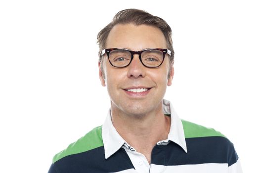 Close up shot of smiling young casual guy wearing spectacles