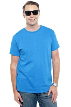 Casual stylish portrait of guy wearing sunglasses. Dressed in casuals
