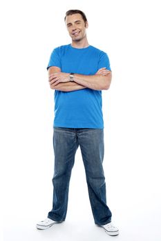 Full length picture of a young casual man. Arms folded and smiling