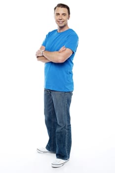 Handsome guy keeping his arms crossed, casual shot on white background