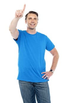 Young smiling male pointing up the copy space isolated over white background