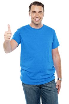 Smart young male showing thumbs up to camera