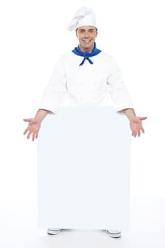 Chef holding blank billboard. Full length shot. Isolated on white