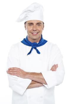 Closeup portrait of smiling young male chef posing casually over white background