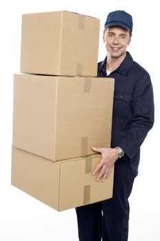 Working man delivering stack of cardboard boxes. Courier delivery