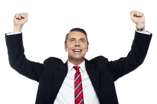 Successful corporate male, arms raised in excitement