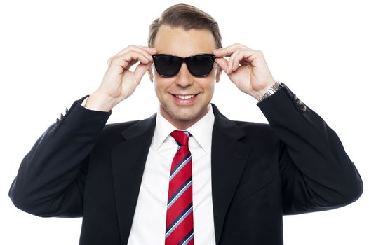 Stylish handsome businessman wearing shades looking at camera