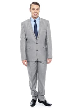 Full length portrait of professional businessman in proper suit