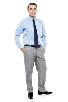 Relaxed young manager posing in style. Hands in trousers pocket