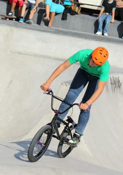 GENEVA, SWITZERLAND - SEPTEMBER 4 : young BMX biker running at the brand new skate park at Plainpalas place, on September 4, 2012 in Geneva, Switzerland.