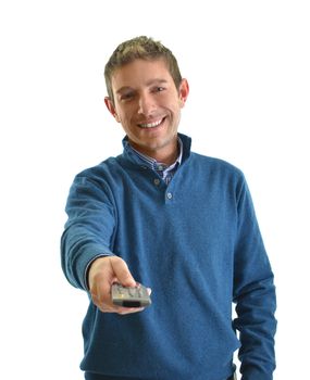 Attractive young man smiling and using TV remote control, isolated on white