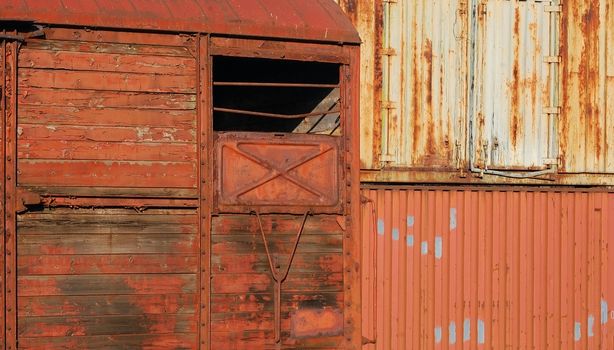 Old wooden wagon and metal containers as background