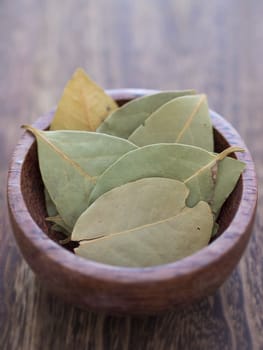 close up of a bowl of dried broad rosemary leaves